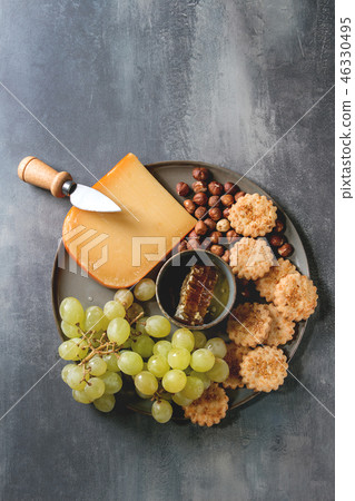 Cheese and grapes appetizer 46330495