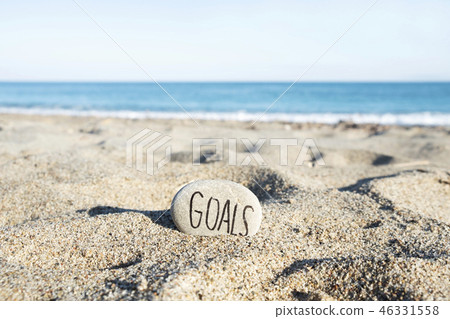 text goals in a stone on the beach 46331558