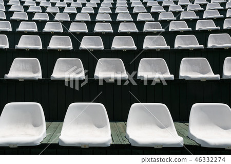 Rows of white chairs in an outdoor hall Rows of white chairs in an outdoor hall 46332274