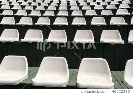 Rows of empty white armchairs in an open hall Rows of empty white armchairs in an open hall 46332280