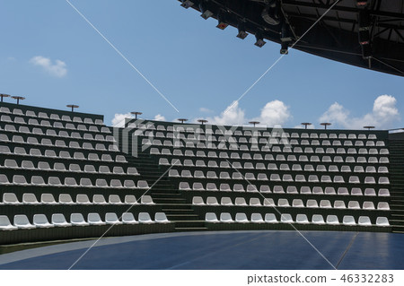 Open stage, lighting equipment, rows of chairs 46332283