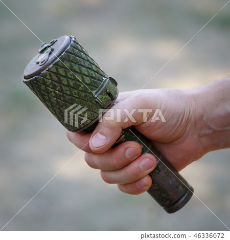 Antitank grenade in the male hand close-up Antitank grenade in the male hand close-up 46336072
