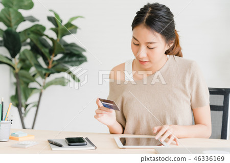 woman using phone buying online by credit card. woman using phone buying online by credit card. 46336169