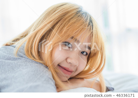 Asian woman on bed at home in the morning. Asian woman on bed at home in the morning. 46336171