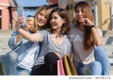 woman using smartphone while shopping in the city. woman using smartphone while shopping in the city. 46336174