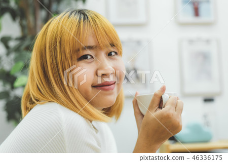 woman enjoying warm coffee in the kitchen at home. woman enjoying warm coffee in the kitchen at home. 46336175