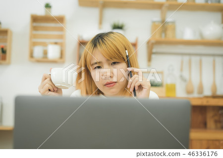 woman working on laptop drink coffee at home. 46336176