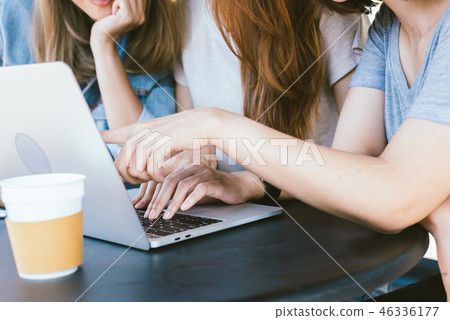 women working together on laptop in cafe. women working together on laptop in cafe. 46336177