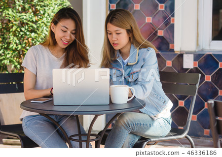 women working together on laptop in cafe. women working together on laptop in cafe. 46336186
