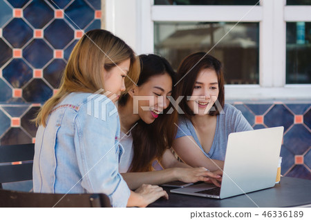 women working together on laptop in cafe. women working together on laptop in cafe. 46336189