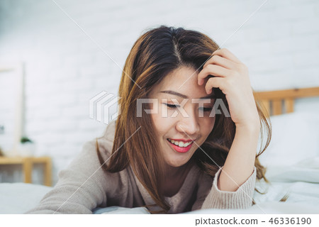 Asian woman on bed at home in the morning.  46336190