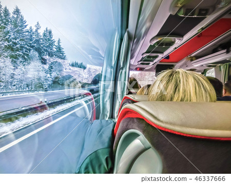 Group of tourist sitting in the bus and looking through the bus windows Group of tourist sitting in the bus and looking through the bus windows 46337666