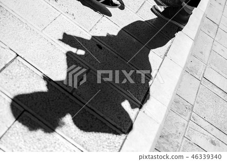 Diagonal shadow of man with shoes, black and white Diagonal shadow of man with shoes, black and white 46339340