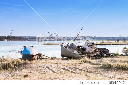 Old Ships On The Riverbank Against A River Port 46340042