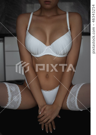 Fitness woman with a beautiful body. Girl in white underwear. 46343254