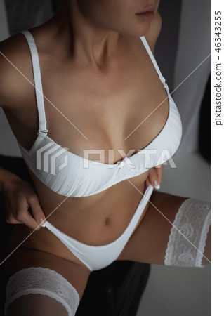 Fitness woman with a beautiful body. Girl in white underwear. 46343255