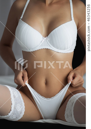 Fitness woman with a beautiful body. Girl in white underwear. 46343256