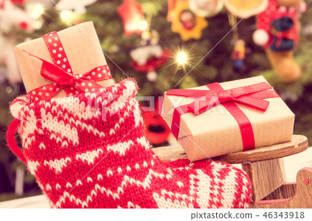 Wrapped gift for Christmas on sled and in red sock 46343918