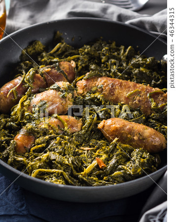 Italian sausages with rapini broccoli in a skillet Italian sausages with rapini broccoli in a skillet 46344315