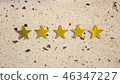 Five golden stars on white stone background 46347227