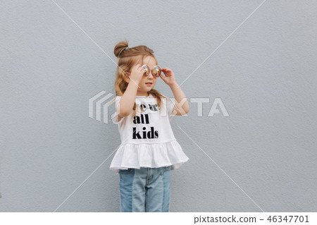 little girl in sunglasses posing to photographer 46347701
