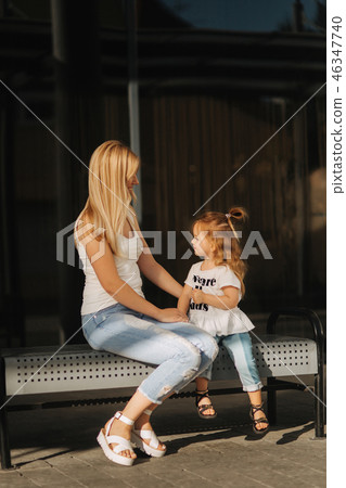 Mother and daughter outdoors in city. playing and having fun. Fashion happy mother and child 46347740