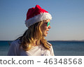 woman in Santa Claus hat.  46348568