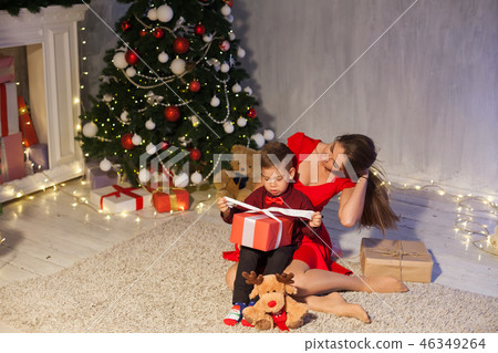 mother and son celebrate the new year Christmas tree gifts 46349264