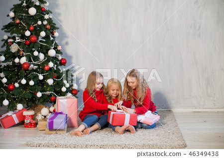 Christmas holiday three girl with gifts the new year tree decoration on a grey background gifts 46349438