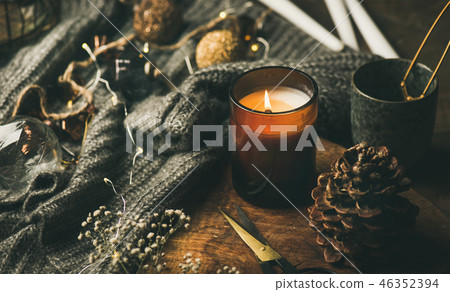 Candle on wooden board, sweater and decoration toys, horizontal composition Candle on wooden board, sweater and decoration toys, horizontal composition 46352394