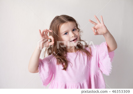 little girl in a pink dress shows hands heart little girl in a pink dress shows hands heart 46353309