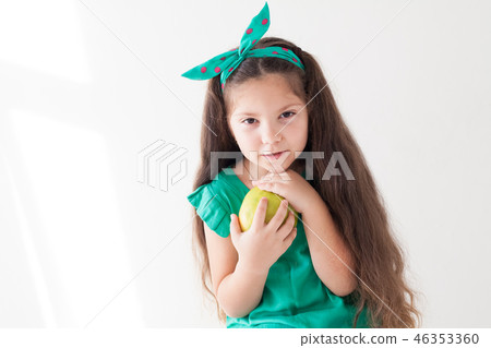 little girl eating a Green Apple fruit vitamins little girl eating a Green Apple fruit vitamins 46353360