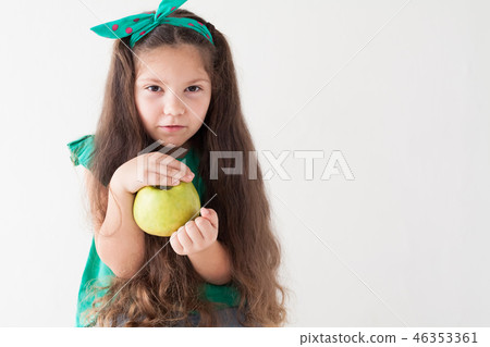little girl eating a Green Apple fruit vitamins little girl eating a Green Apple fruit vitamins 46353361
