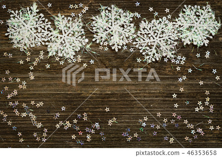 Snowflakes on dark wood Snowflakes on dark wood 46353658