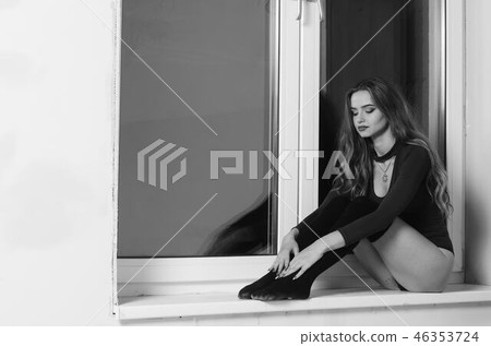 Sexy young woman with big breast. Girl posing on black wall in studio. Sexy young woman with big breast. Girl posing on black wall in studio. 46353724