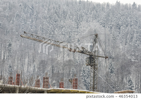 Construction crane on the background of snowy 46354013