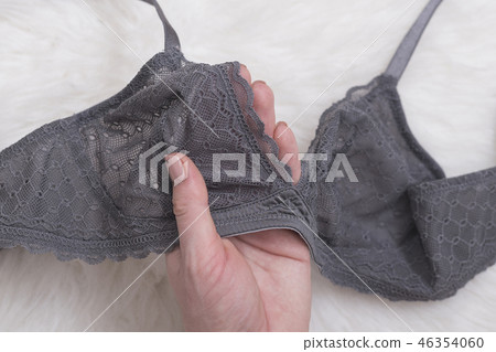 Gray lace bra in female hand. Fashion concept 46354060