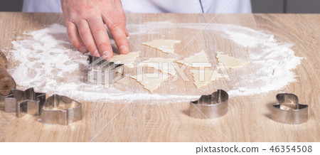 male cook preparing Christmas cookies male cook preparing Christmas cookies 46354508