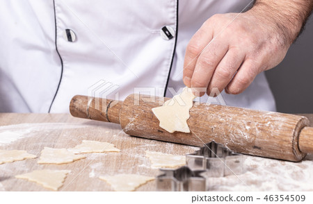 male cook preparing Christmas cookies male cook preparing Christmas cookies 46354509