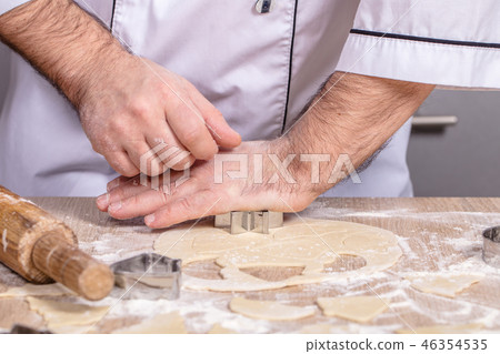 male cook preparing Christmas cookies 46354535