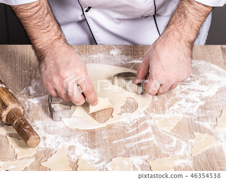 male cook preparing Christmas cookies 46354538