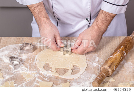 male cook preparing Christmas cookies 46354539