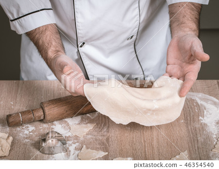 male cook preparing Christmas cookies 46354540