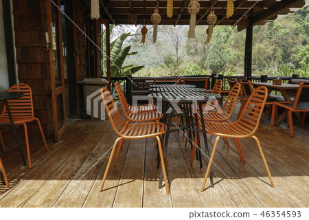 Orange outdoor tablean chairs in bistro cafe 46354593