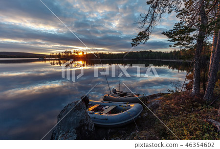 Fishing boats near the lake at sunset. 46354602