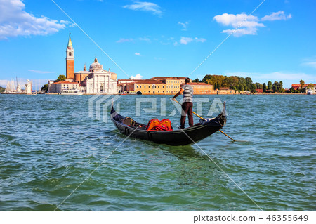 A gondolier in Venice going to San Giorgio Maggiore island, Ital A gondolier in Venice going to San Giorgio Maggiore island, Ital 46355649