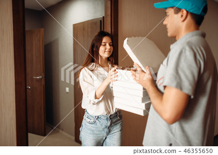 Female customer and delivery boy checks pizza Female customer and delivery boy checks pizza 46355650