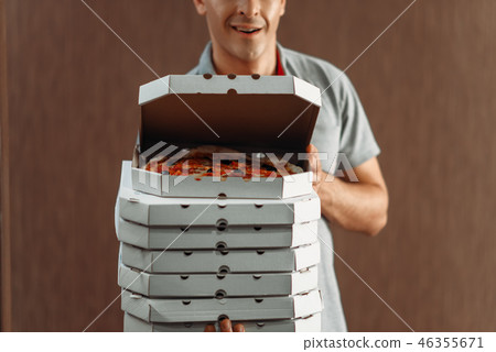 Delivery man shows fresh pizza, delivering service Delivery man shows fresh pizza, delivering service 46355671