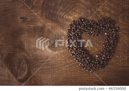 Heart shape made from coffee beans on the dark wooden background Heart shape made from coffee beans on the dark wooden background 46356000