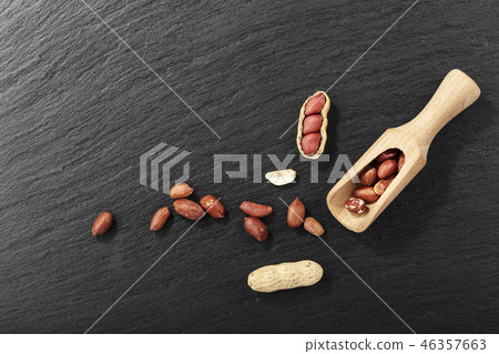 peanuts on black background peanuts on black background 46357663